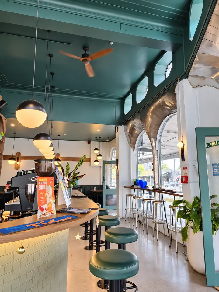 Pendant lights, green arches and window seating inside Hood Street Bistro
